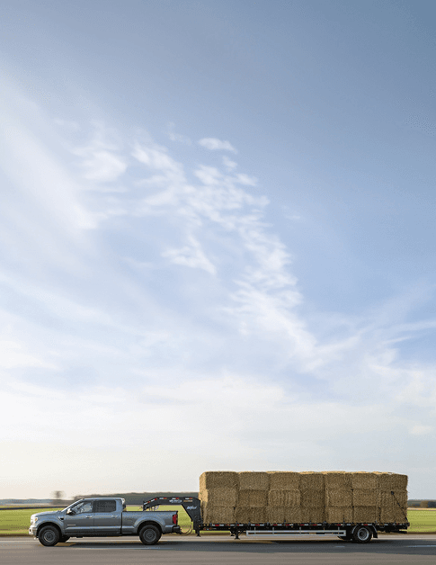 Flatbed trailer loaded with hay bales for delivery